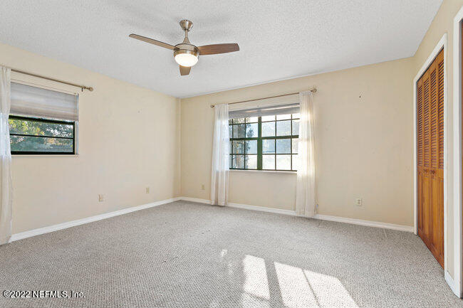 361 Shamrock Road St. Augustine, FL 32086 - Photo 17 of 30 an empty room with a window and a ceiling fan