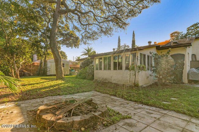 361 Shamrock Road St. Augustine, FL 32086 - Photo 26 of 30 a view of a white house next to a yard with big trees