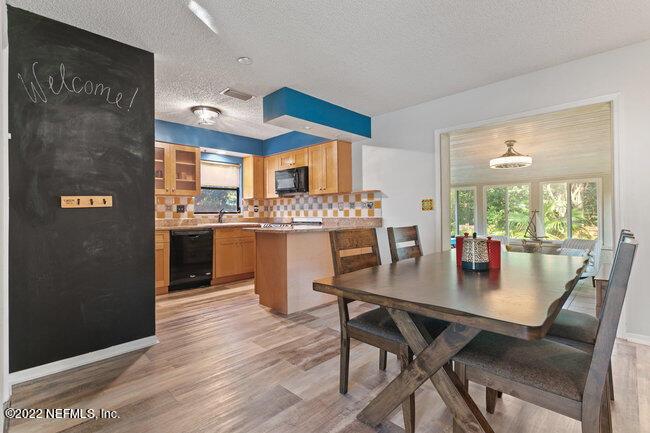 361 Shamrock Road St. Augustine, FL 32086 - Photo 7 of 30 a kitchen with a dining table chairs and refrigerator