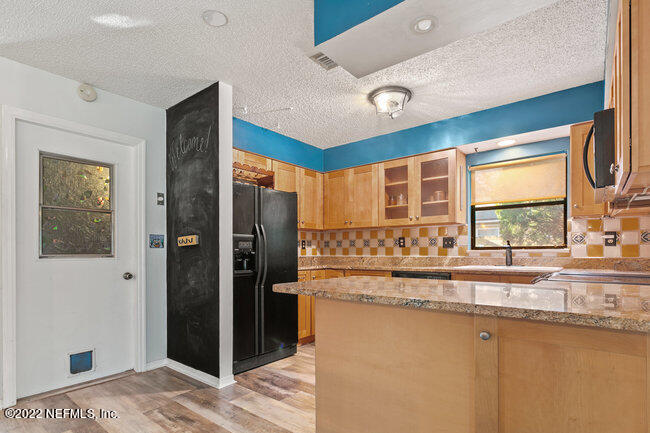 361 Shamrock Road St. Augustine, FL 32086 - Photo 10 of 30 a kitchen with stainless steel appliances granite countertop a refrigerator and a sink