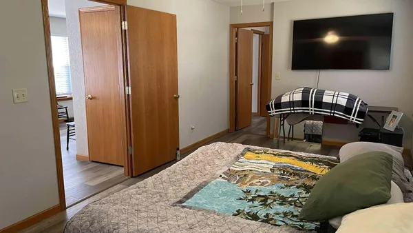 a bedroom with a bed and a flat screen tv
