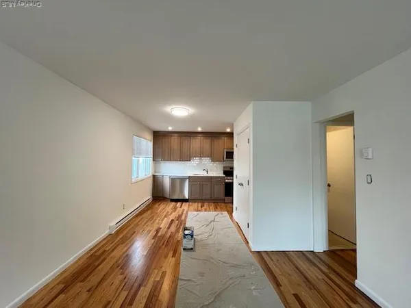 a view of a room with wooden floor