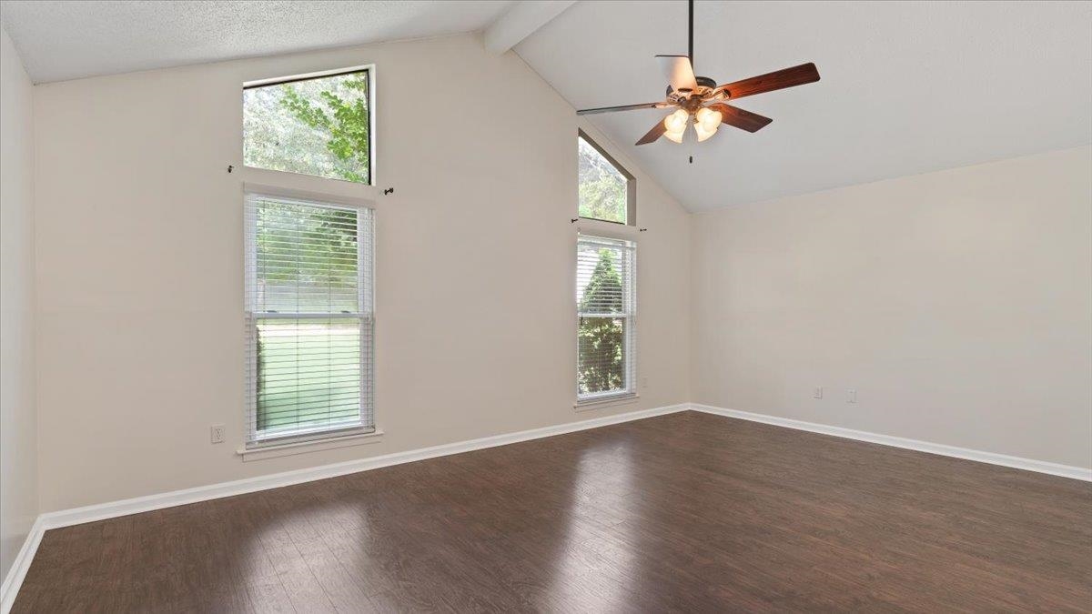 1707 Falling Leaf Road Germantown, TN 38138 - Photo 19 of 38 Empty room with beamed ceiling, high vaulted ceiling, dark hardwood / wood-style floors, and ceiling fan