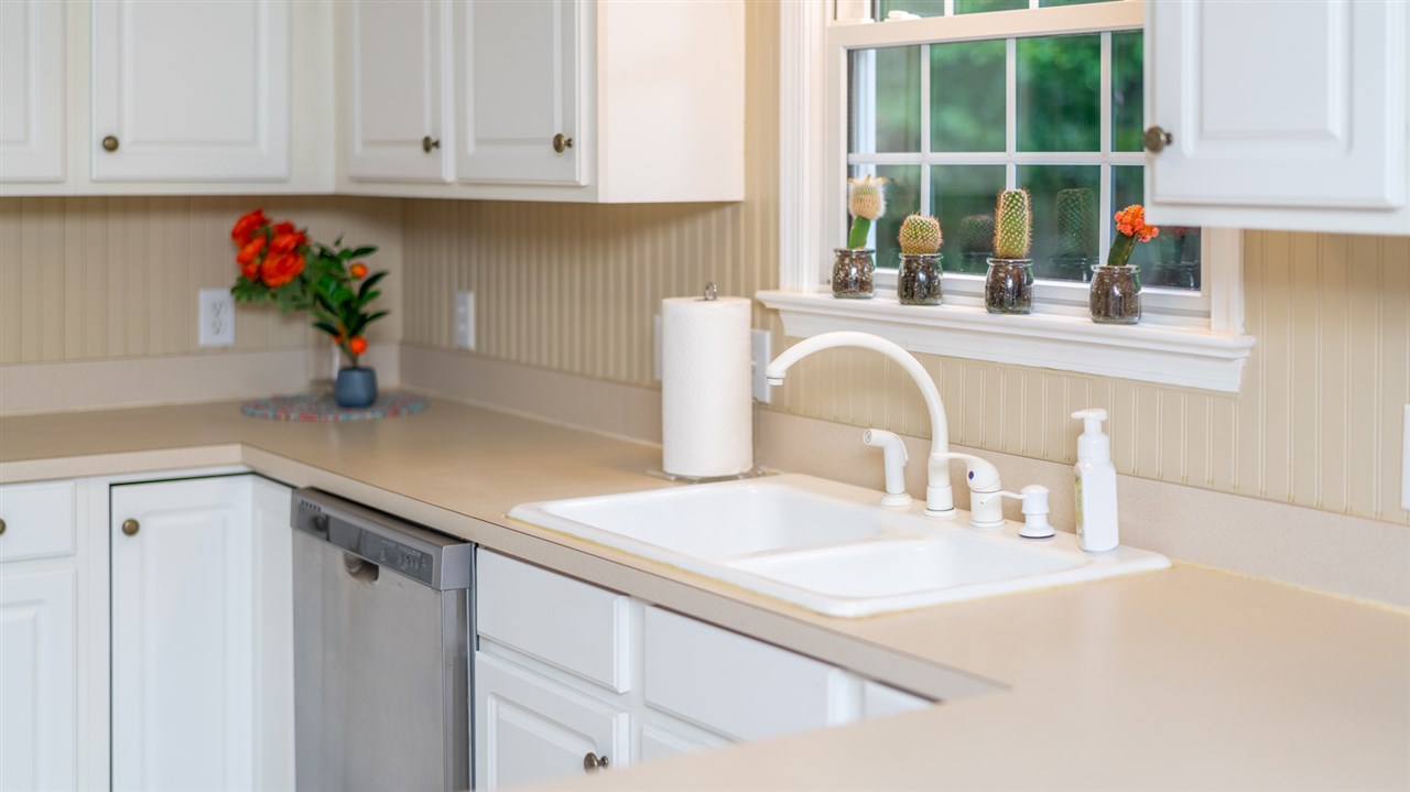 65 Long Bow Road Waynesboro, VA 22980 - Photo 29 of 50 a kitchen with stainless steel appliances granite countertop a sink dishwasher and cabinets with wooden floor