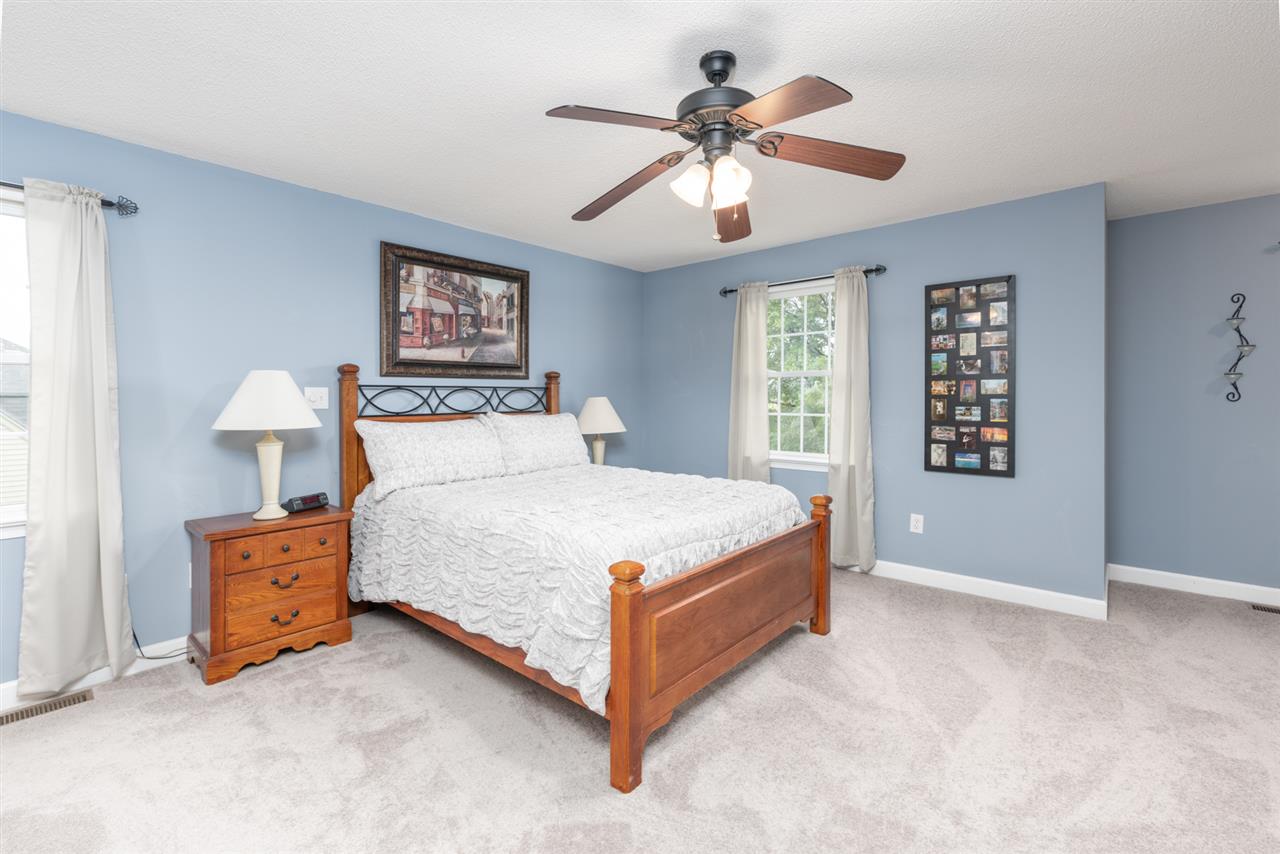65 Long Bow Road Waynesboro, VA 22980 - Photo 38 of 50 a bedroom with a large bed and a chandelier