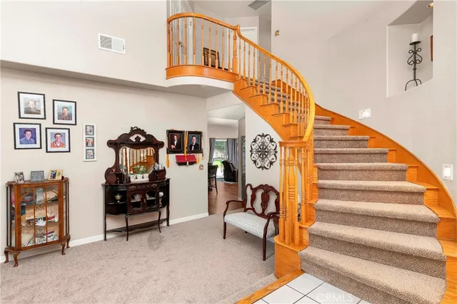 a kitchen with a sink dishwasher a stove and a dining table with wooden floor