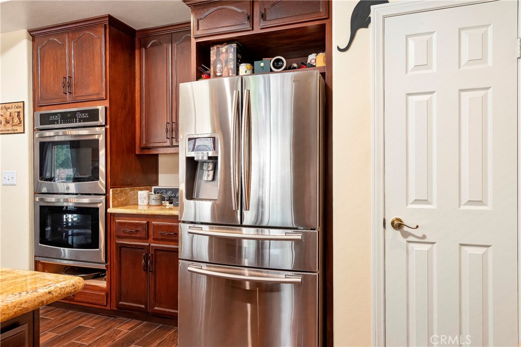 32201 Joaquin Road Acton, CA 93510 - Photo 24 of 75 a kitchen with stainless steel appliances granite countertop a refrigerator and a stove top oven