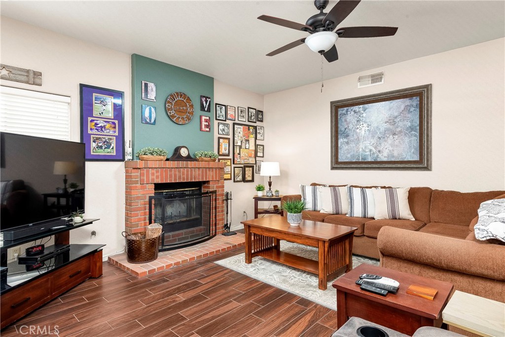 32201 Joaquin Road Acton, CA 93510 - Photo 27 of 75 a living room with furniture a flat screen tv and a fireplace