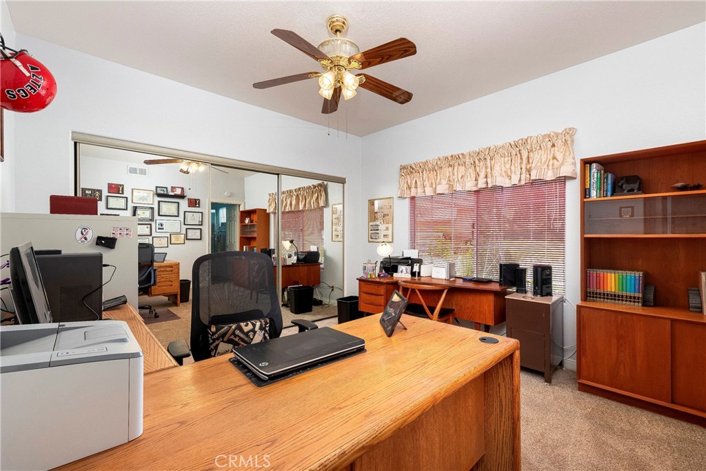 32201 Joaquin Road Acton, CA 93510 - Photo 30 of 75 a living room with furniture a dining table and a bookshelf