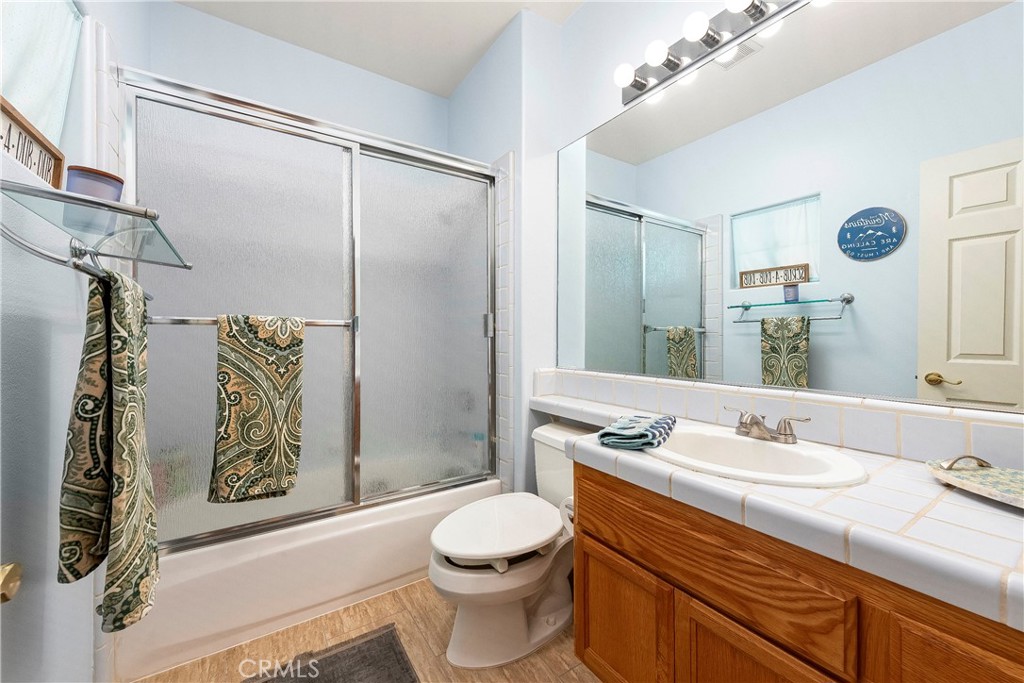 32201 Joaquin Road Acton, CA 93510 - Photo 31 of 75 a bathroom with a granite countertop sink toilet and shower
