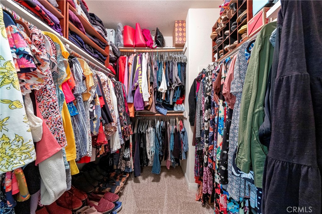 32201 Joaquin Road Acton, CA 93510 - Photo 36 of 75 a view of walk in closet with clothes