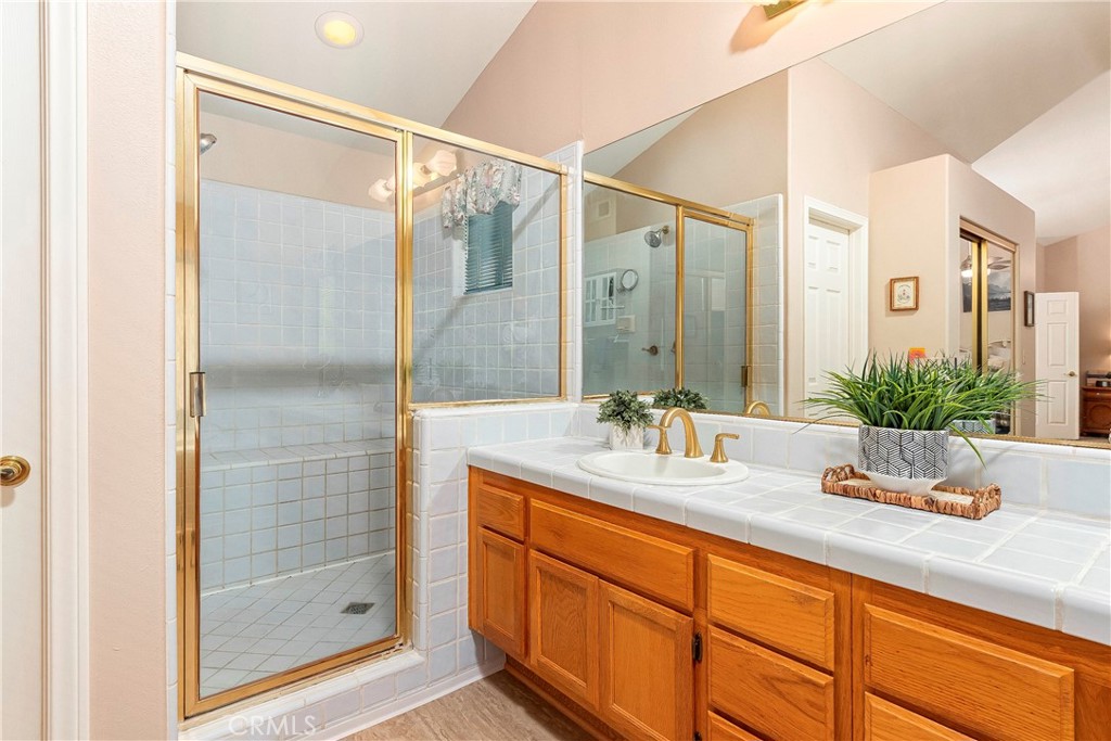 32201 Joaquin Road Acton, CA 93510 - Photo 38 of 75 a bathroom with a granite countertop sink and a mirror