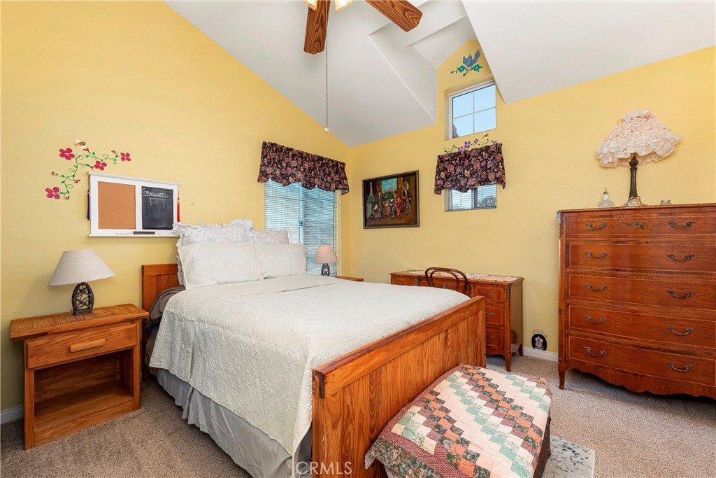 32201 Joaquin Road Acton, CA 93510 - Photo 40 of 75 a bedroom with a bed and a chandelier