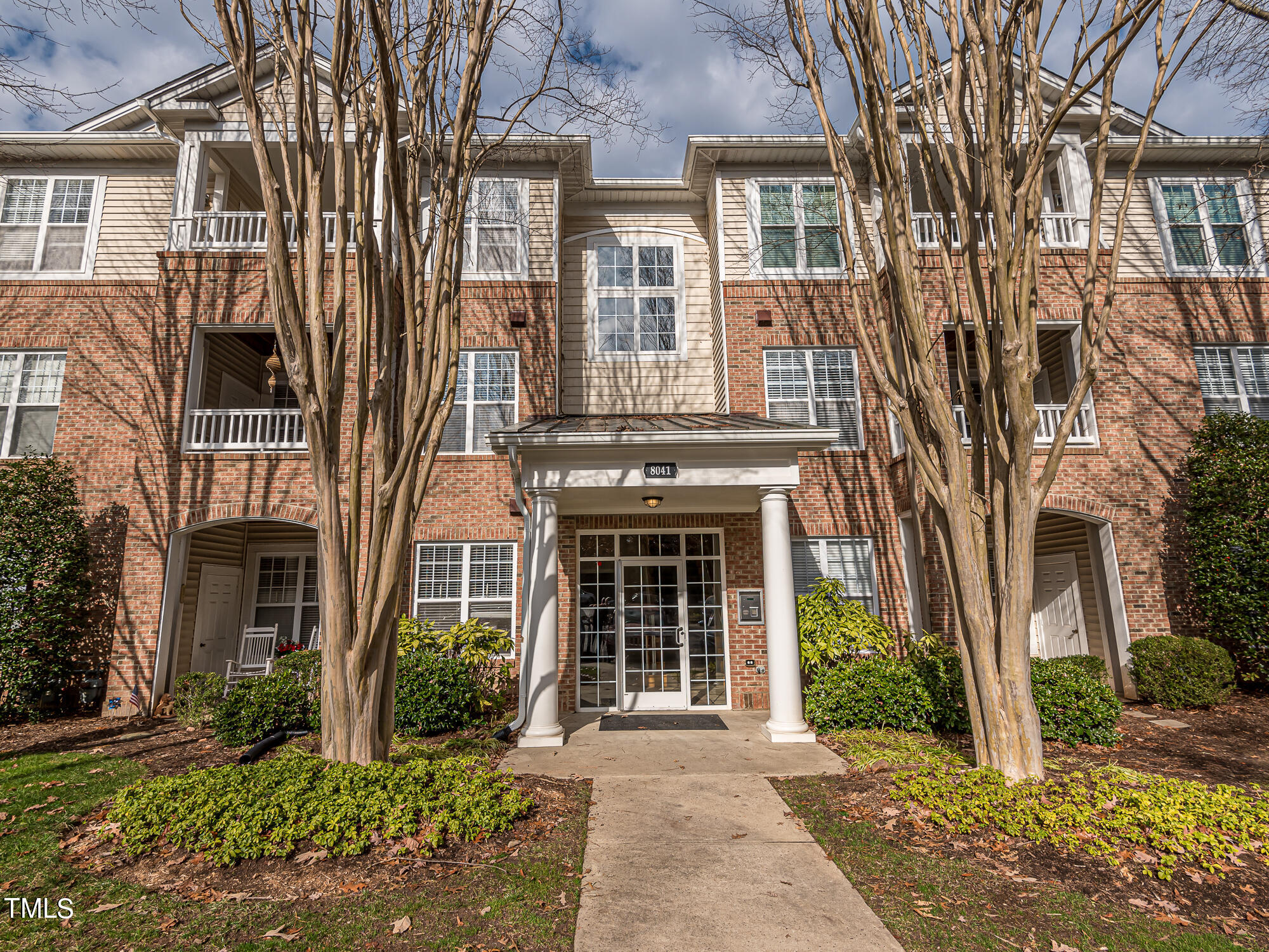 8041 Allyns Landing Way, Unit 103 Raleigh, NC 27615 - Photo 2 of 33 front view of a brick house with a large window and a yard