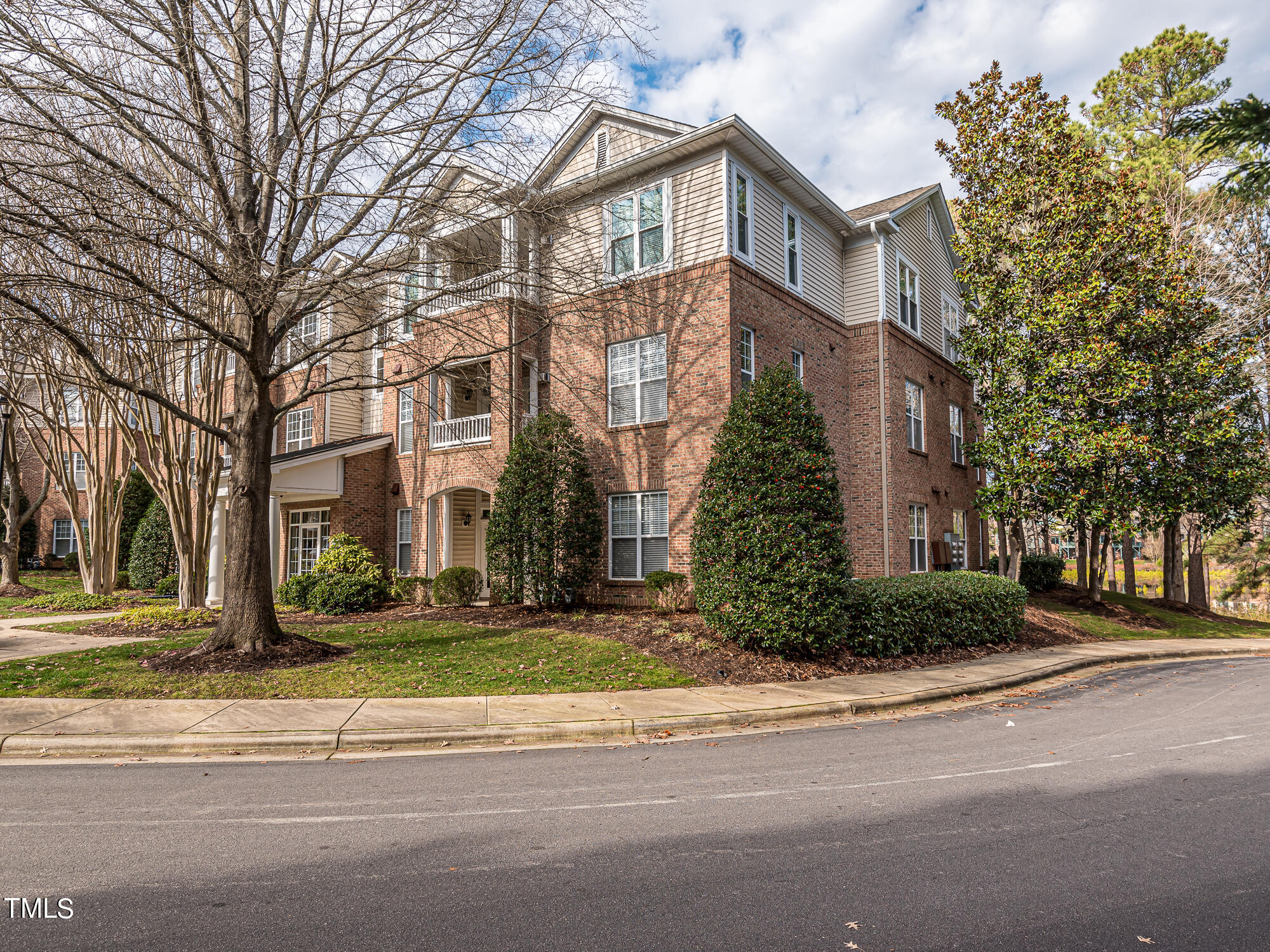 8041 Allyns Landing Way, Unit 103 Raleigh, NC 27615 - Photo 32 of 33 front view of a brick house with a yard