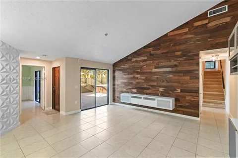 a view of a kitchen with an empty space and a window