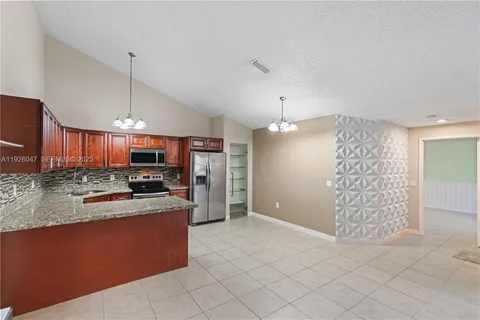 a view of a livingroom with a furniture and floor to ceiling window