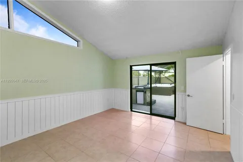 a view of a hallway with wooden floor and entryway