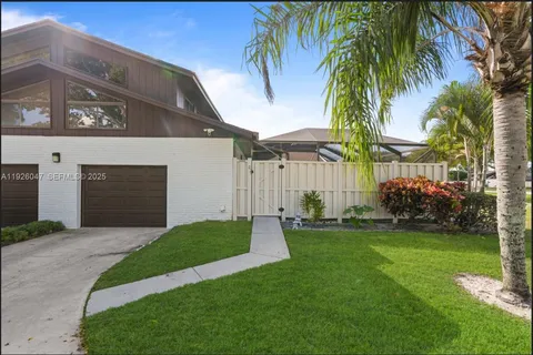 a front view of a house with a garden and yard