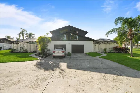 an aerial view of a house with garden space and street view