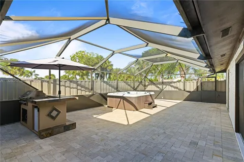 a large kitchen with stainless steel appliances kitchen island granite countertop a refrigerator and a stove