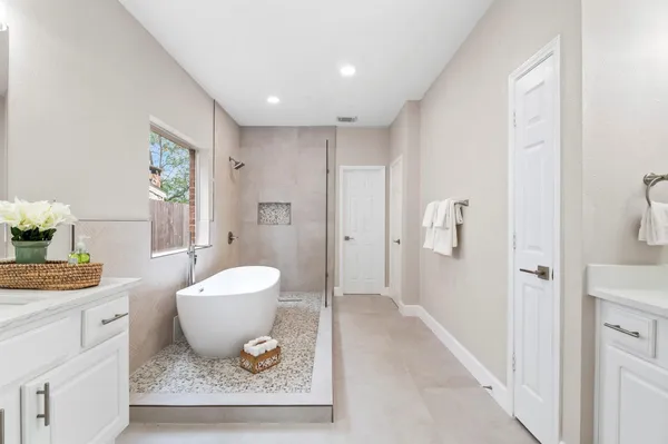 a spacious bathroom with a granite countertop sink and a mirror