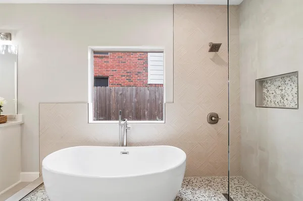 a bathroom with a tub and a shower