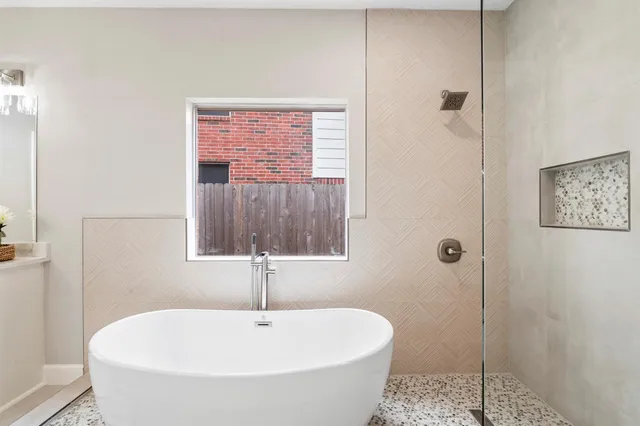 a bathroom with a tub and a shower