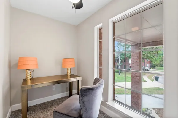 a living room with furniture and a lamp