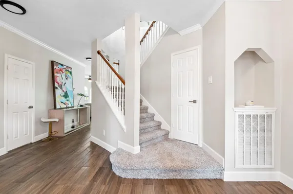 a view of entryway and hall with wooden floor