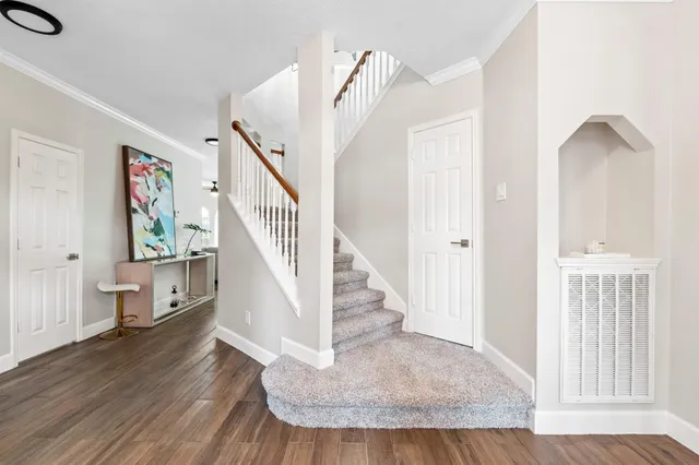a view of entryway and hall with wooden floor