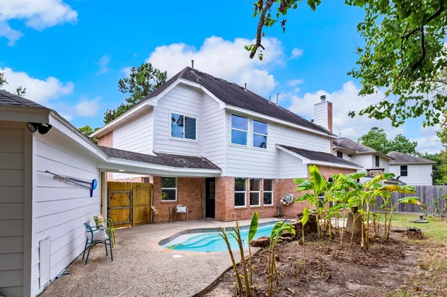 a view of a house with a yard and sitting area