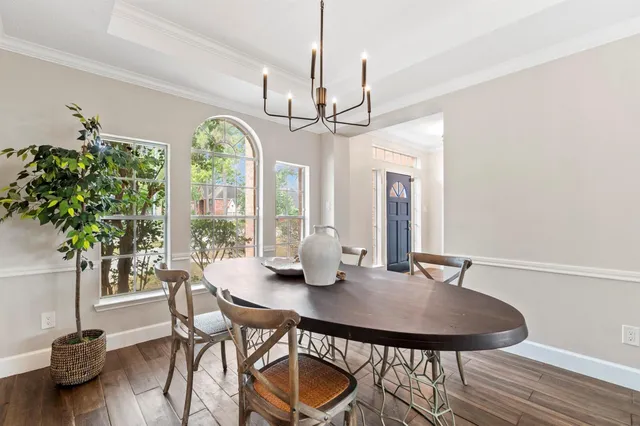 a view of a dining room with furniture window and wooden floor