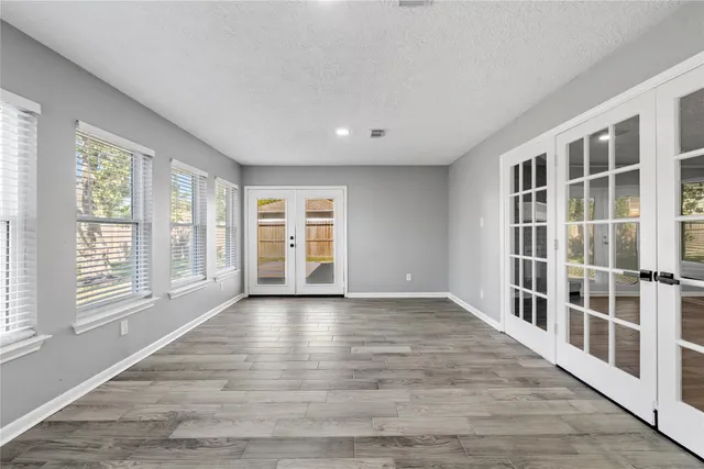 an empty room with fan and windows