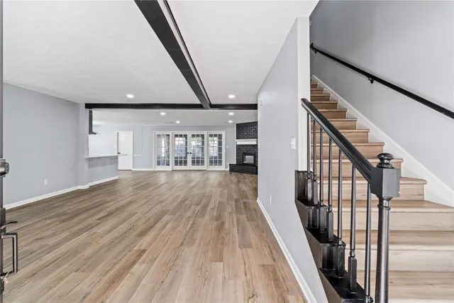 a view of entryway with wooden floor and stairs