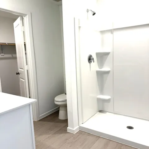 a bathroom with a toilet a sink and shower