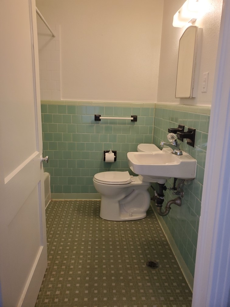 615 Pecan Street Junction, TX 76849 - Photo 12 of 14 a bathroom with a sink toilet and a mirror