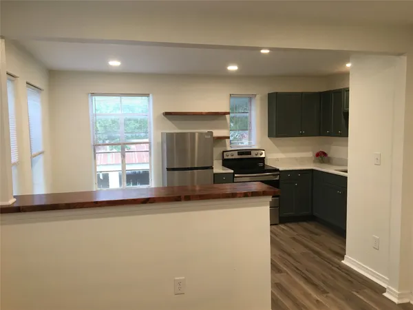 a kitchen with a sink and a stove top oven