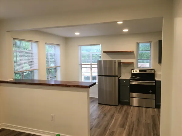 a kitchen with a refrigerator and a sink