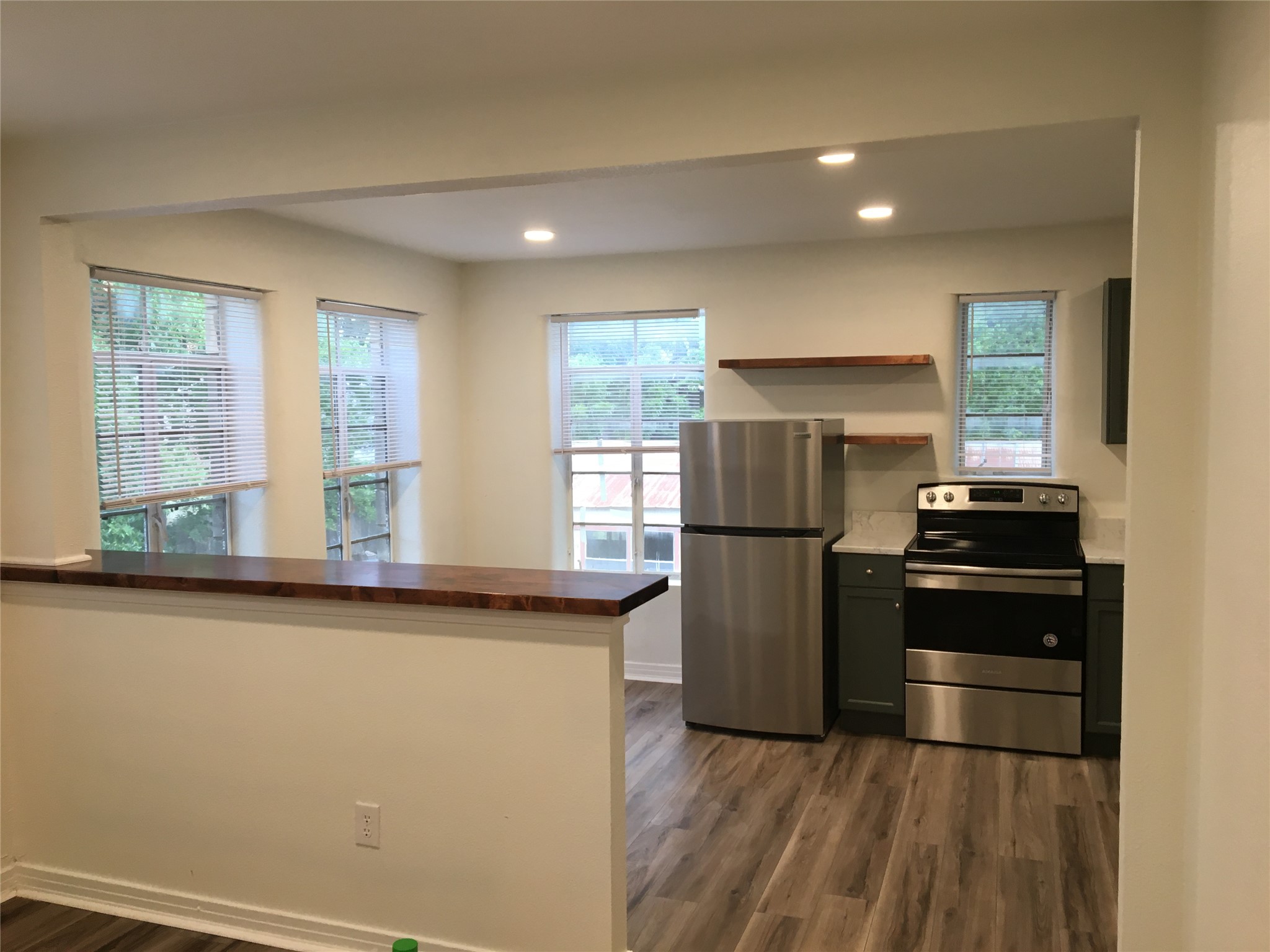 615 Pecan Street Junction, TX 76849 - Photo 9 of 14 a kitchen with a refrigerator and a sink
