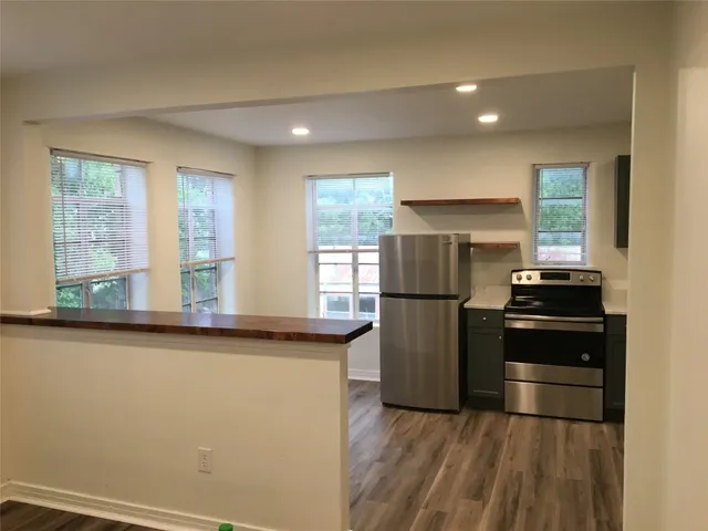 a kitchen with a refrigerator and a sink