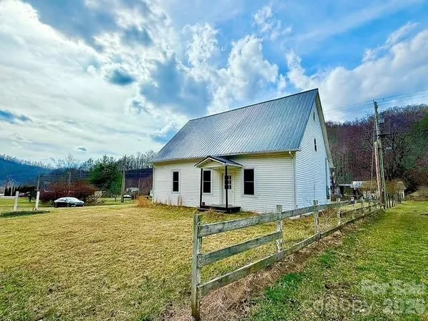 a house view with swimming pool and yard