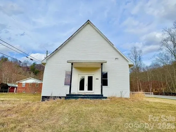 a view of entryway and kitchen with wooden floor
