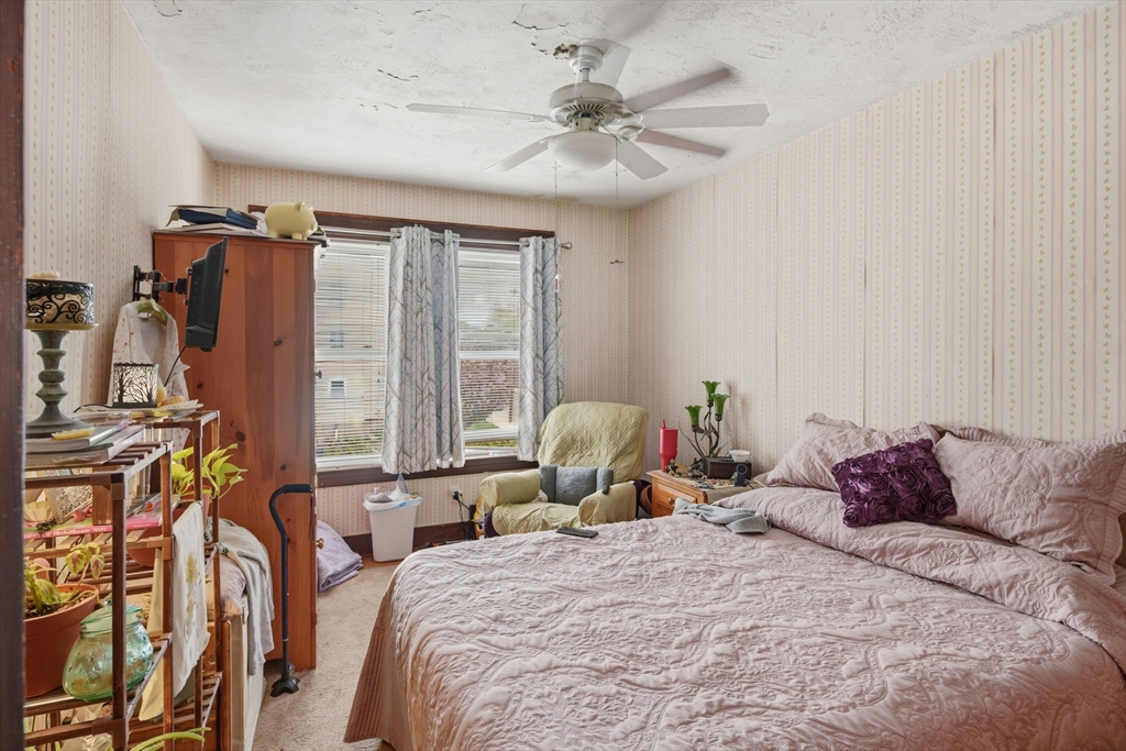 612 Rathbun Street Blackstone, MA 01504 - Photo 33 of 41 a bedroom with a bed and a chandelier