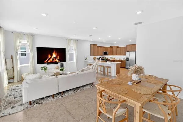 a living room with kitchen island furniture and a flat screen tv