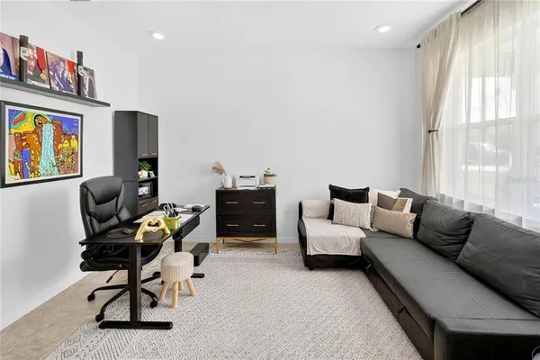 a living room with furniture and painting on the wall