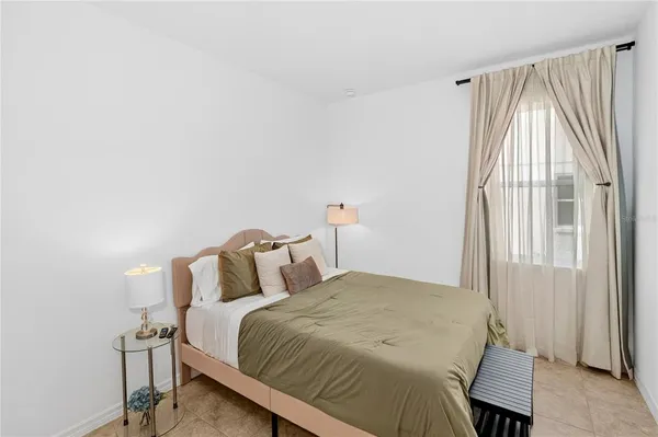 a bedroom with a bed and a window