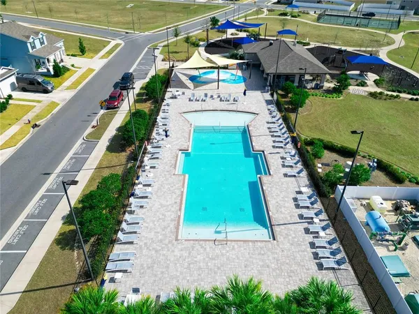 a view of a tennis ground with large trees