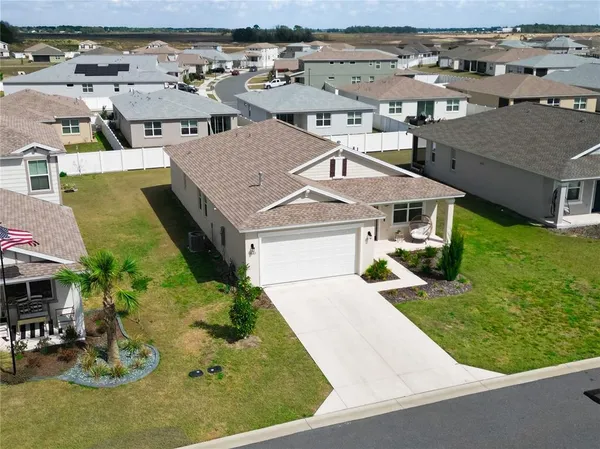 an aerial view of a house with garden space and street view