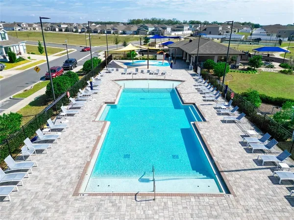 a view of a swimming pool with an outdoor seating